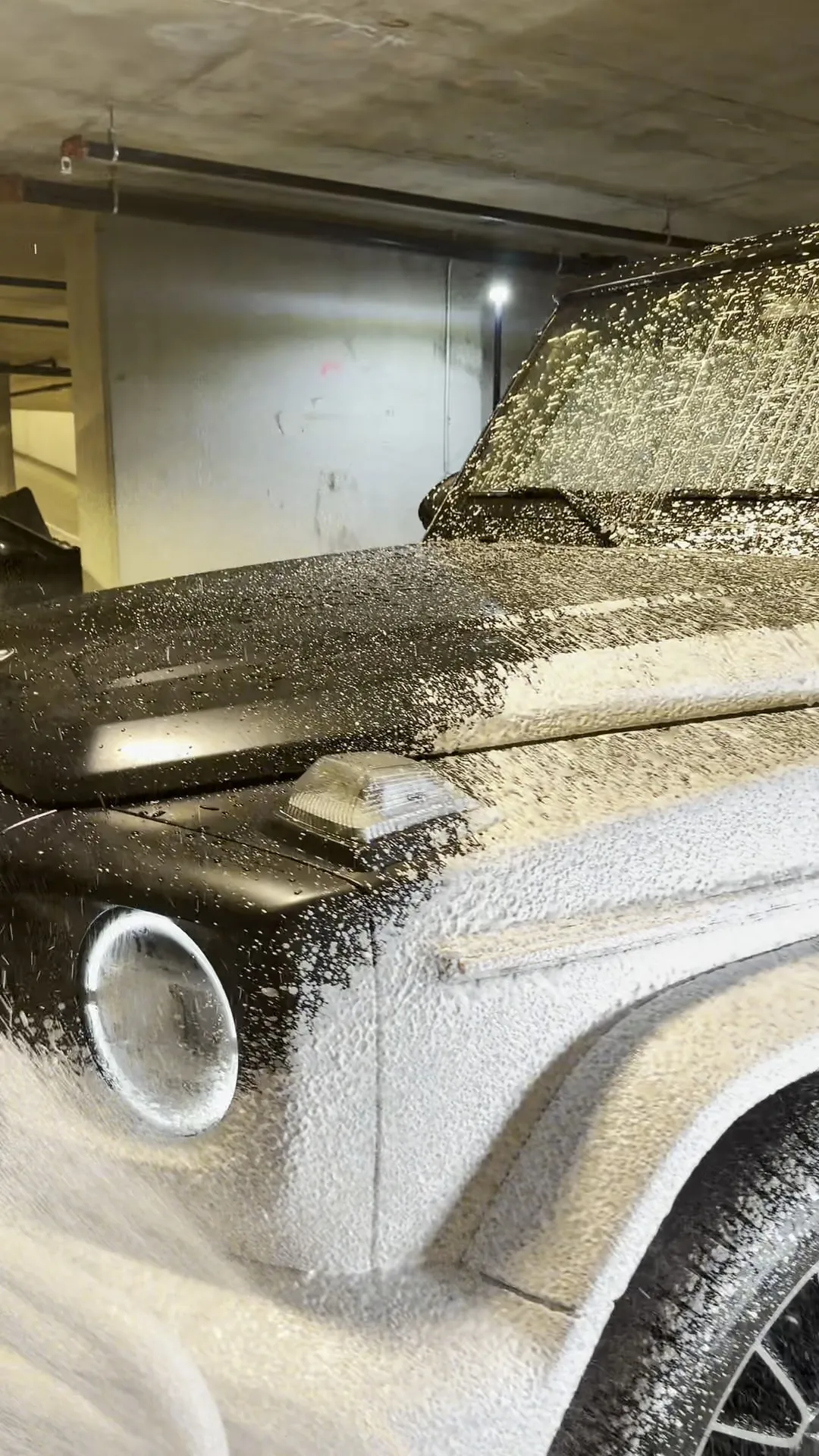 Mercedes G-Wagon covered in pre-wash foam during exterior decontamination
