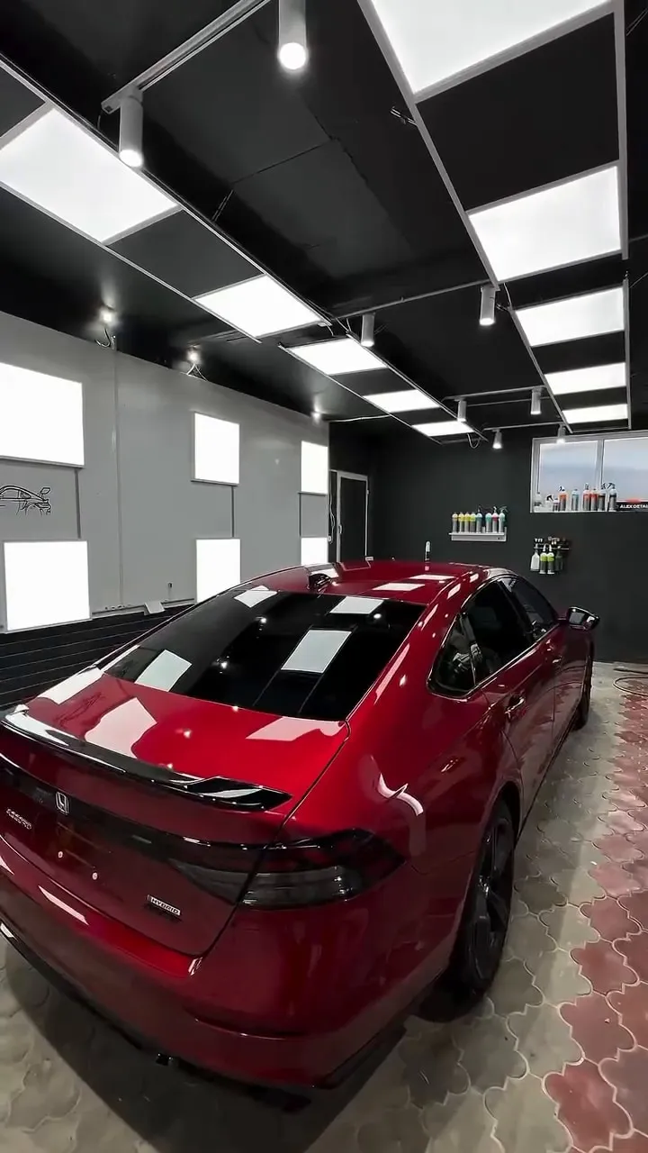 Honda sedan after a full detail, rear three-quarter view in the detailing bay